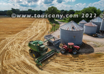 John Deere Combine transferring winter wheat to grain cart photo